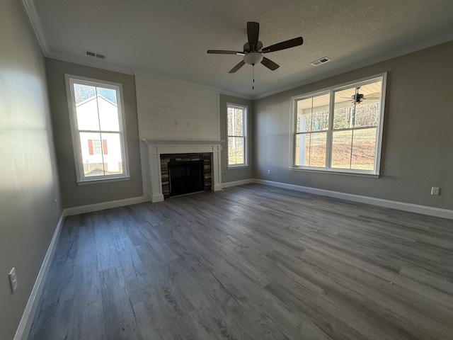 unfurnished living room featuring crown molding, hardwood / wood-style floors, ceiling fan, and a textured ceiling