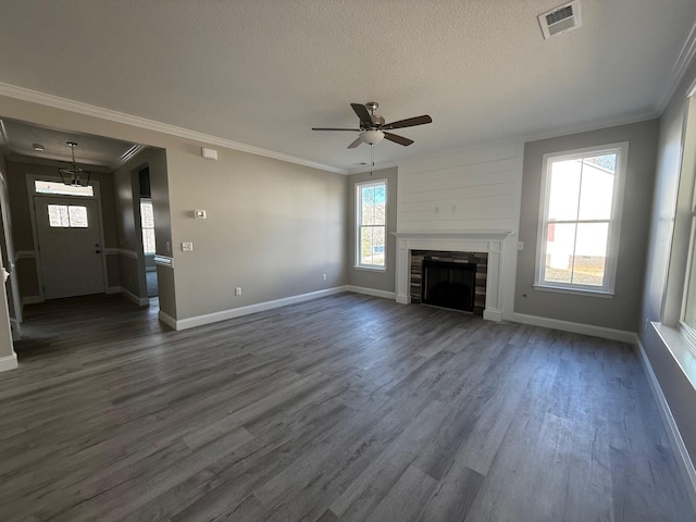 unfurnished living room featuring dark hardwood / wood-style flooring, a wealth of natural light, and a textured ceiling