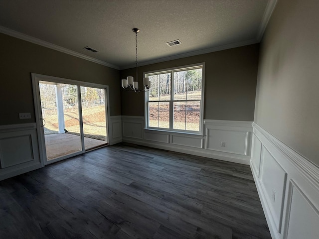 unfurnished dining area featuring a textured ceiling, a chandelier, and a healthy amount of sunlight