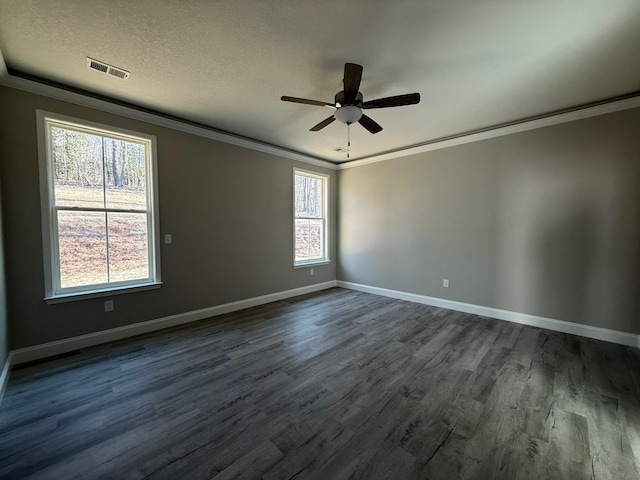 spare room with ceiling fan, dark wood-type flooring, ornamental molding, and a textured ceiling