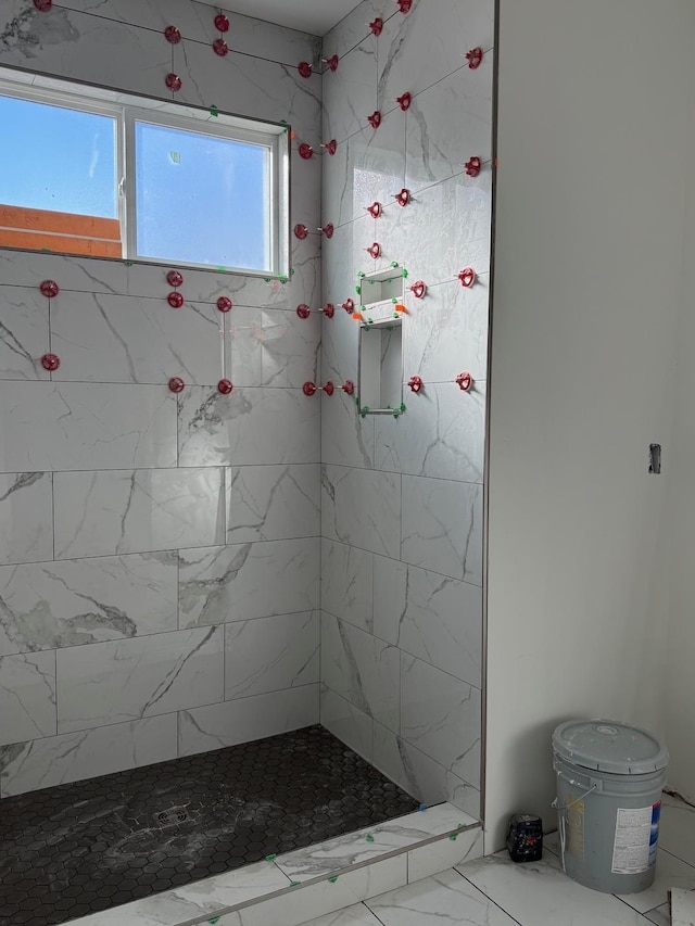 bathroom with a tile shower