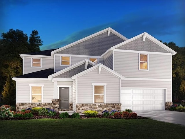 craftsman-style home featuring a lawn and a garage