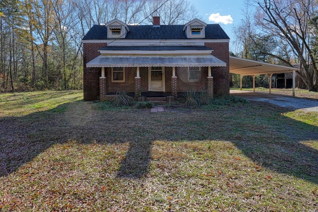 view of front of property with a porch, a front yard, and a carport