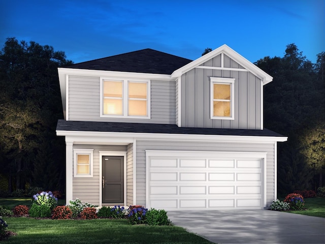 view of front of property featuring a front yard and a garage