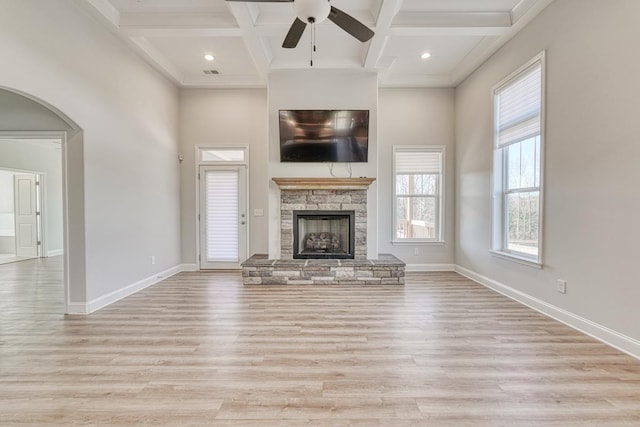 unfurnished living room featuring light hardwood / wood-style floors, ceiling fan, and coffered ceiling