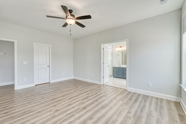 unfurnished bedroom featuring ensuite bath, ceiling fan, and light hardwood / wood-style flooring