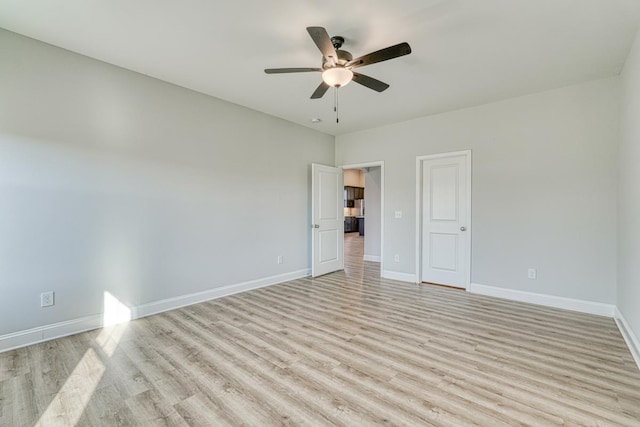 empty room with light wood-type flooring and ceiling fan