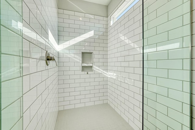 bathroom with a tile shower