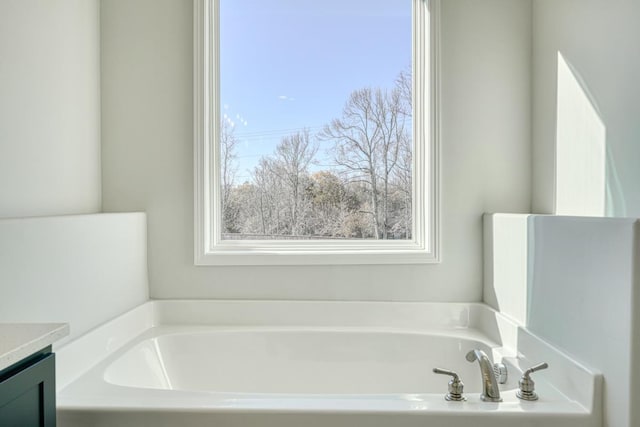 bathroom with vanity and a washtub