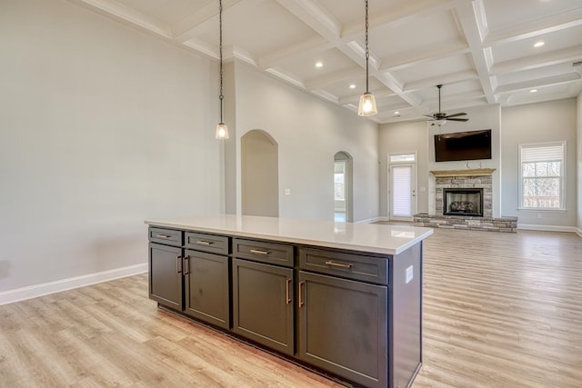 kitchen featuring light hardwood / wood-style flooring, a center island, and decorative light fixtures