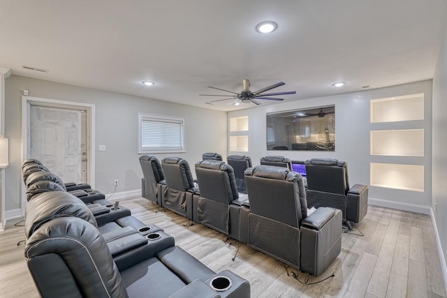 home theater with ceiling fan and light hardwood / wood-style floors