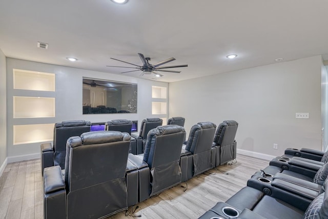 cinema room featuring ceiling fan and light hardwood / wood-style flooring