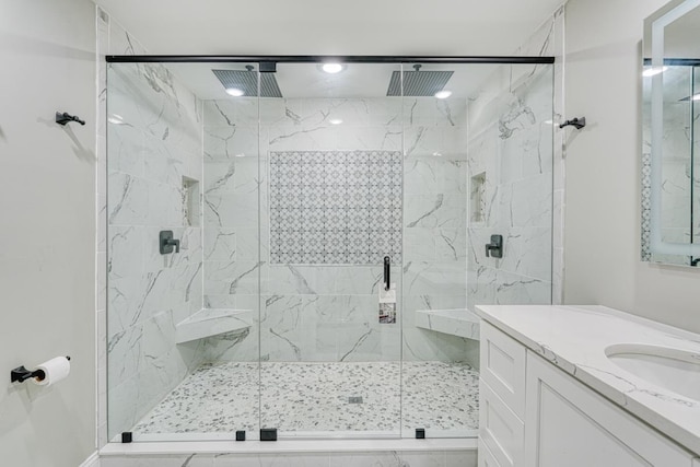 bathroom with vanity and a shower with shower door