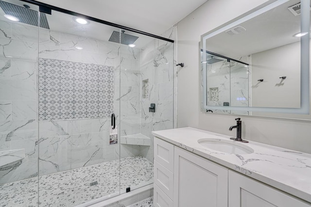 bathroom with vanity and a shower with door