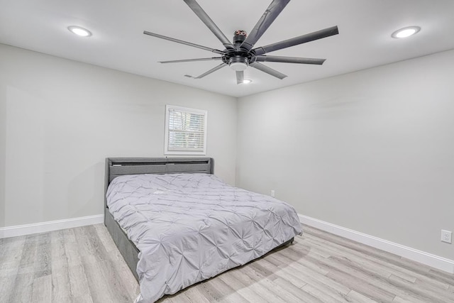 bedroom with light hardwood / wood-style flooring and ceiling fan