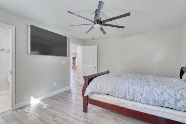 bedroom featuring connected bathroom, light hardwood / wood-style flooring, and ceiling fan