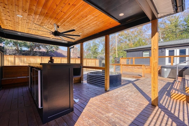 wooden deck with ceiling fan and an outdoor bar