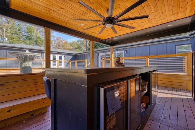 deck with a bar and ceiling fan