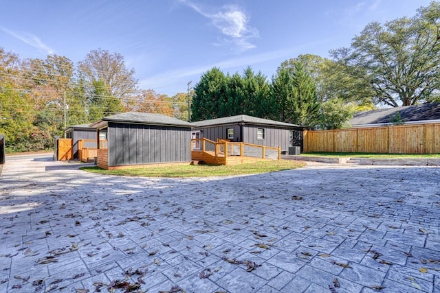 back of property featuring an outbuilding and central air condition unit