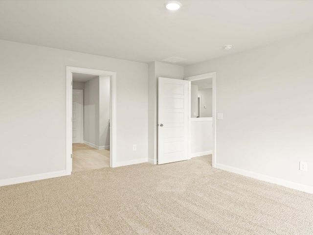 unfurnished bedroom featuring light carpet