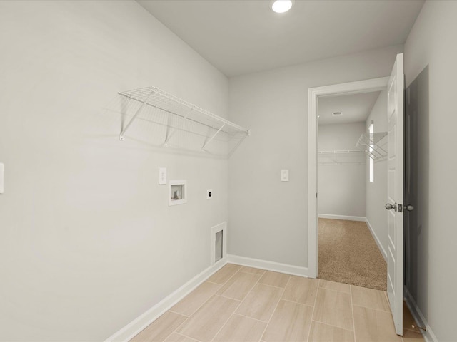 clothes washing area featuring hookup for a washing machine and hookup for an electric dryer