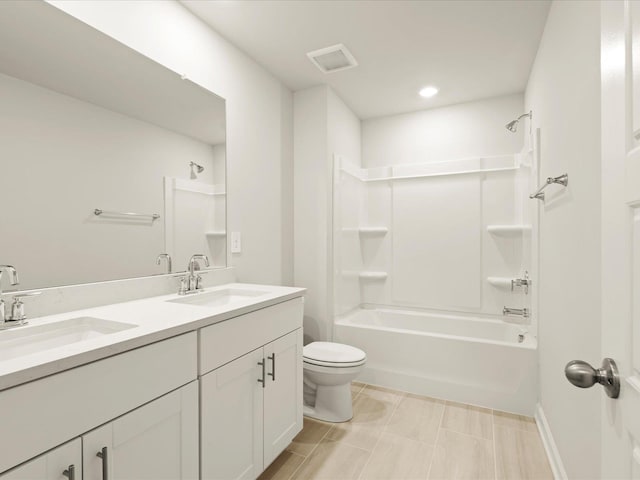 full bathroom featuring toilet, vanity, and washtub / shower combination