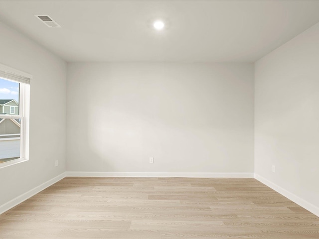 unfurnished room with light wood-type flooring