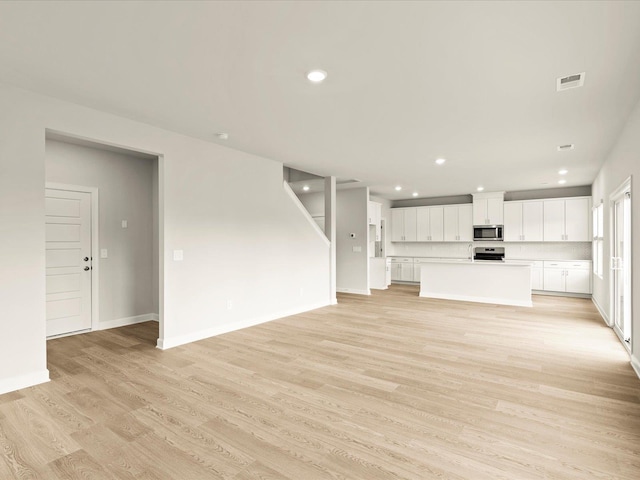 unfurnished living room featuring light wood-type flooring