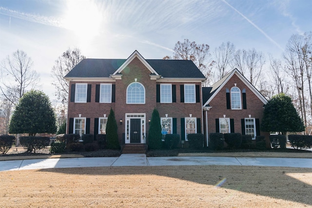 colonial-style house with a front yard