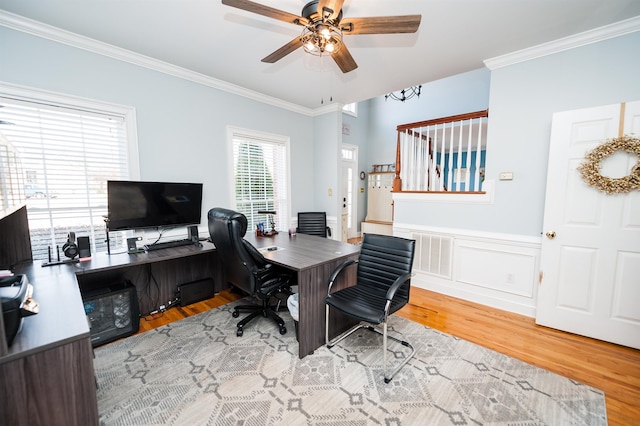 office space featuring ceiling fan, light wood-type flooring, and ornamental molding