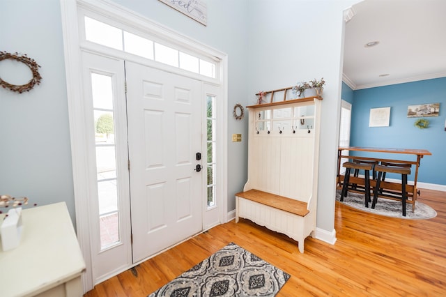 entryway featuring crown molding and hardwood / wood-style floors