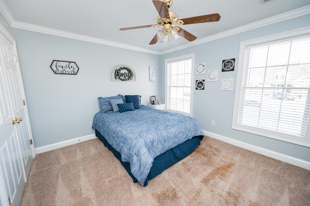 carpeted bedroom featuring ceiling fan and ornamental molding