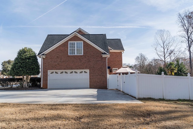 view of home's exterior featuring a garage and a yard