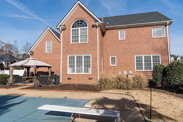 rear view of house featuring a gazebo, a patio area, and a covered pool