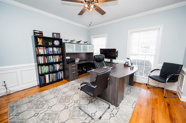 office space with light hardwood / wood-style floors, ceiling fan, and ornamental molding