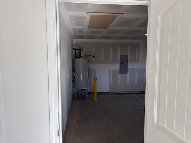 garage featuring electric panel and water heater