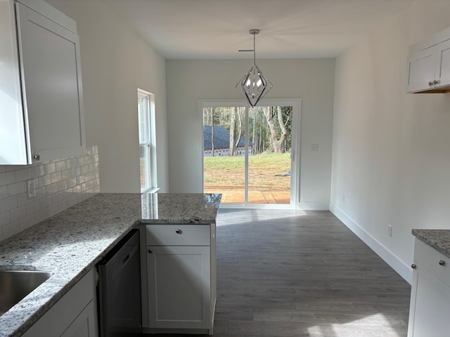 kitchen featuring light stone countertops, dishwashing machine, pendant lighting, white cabinets, and dark hardwood / wood-style floors