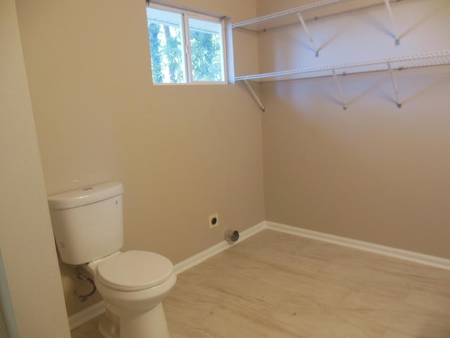 bathroom featuring hardwood / wood-style floors and toilet