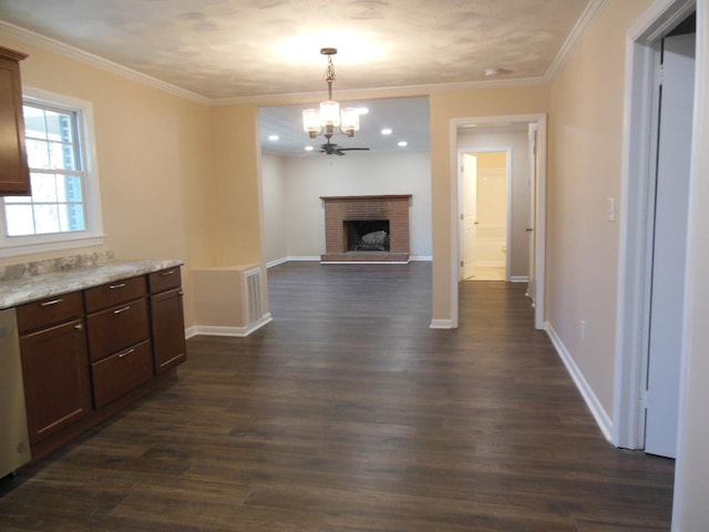 interior space with ceiling fan with notable chandelier, dark hardwood / wood-style flooring, crown molding, and a brick fireplace