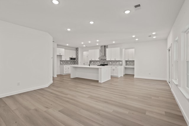 unfurnished living room with light hardwood / wood-style flooring