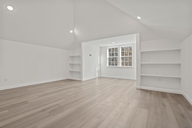 bonus room featuring lofted ceiling and light wood-type flooring