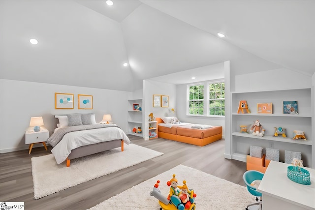 bedroom featuring light wood-type flooring and lofted ceiling