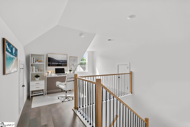 corridor featuring hardwood / wood-style floors and vaulted ceiling