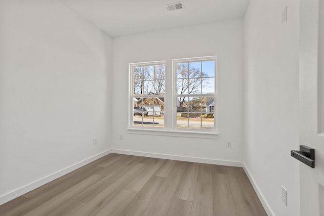 unfurnished room with light hardwood / wood-style floors