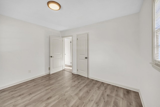 spare room featuring light hardwood / wood-style floors