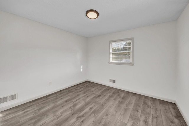 spare room featuring light wood-type flooring