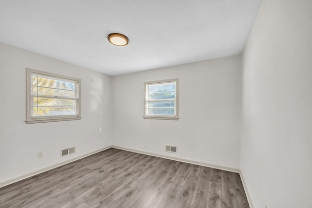 spare room featuring light hardwood / wood-style flooring