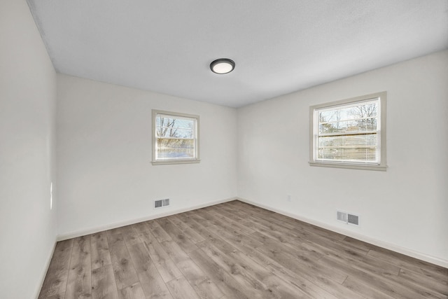 spare room with light wood-type flooring