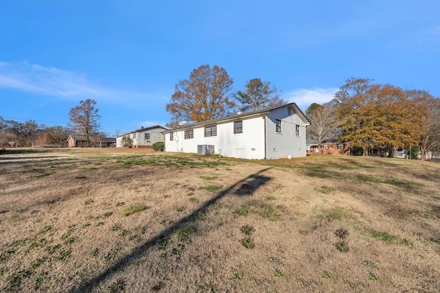 exterior space featuring central AC and a lawn