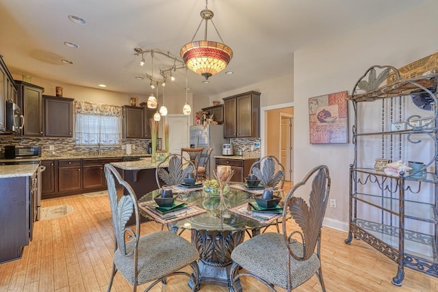 dining space with light hardwood / wood-style floors